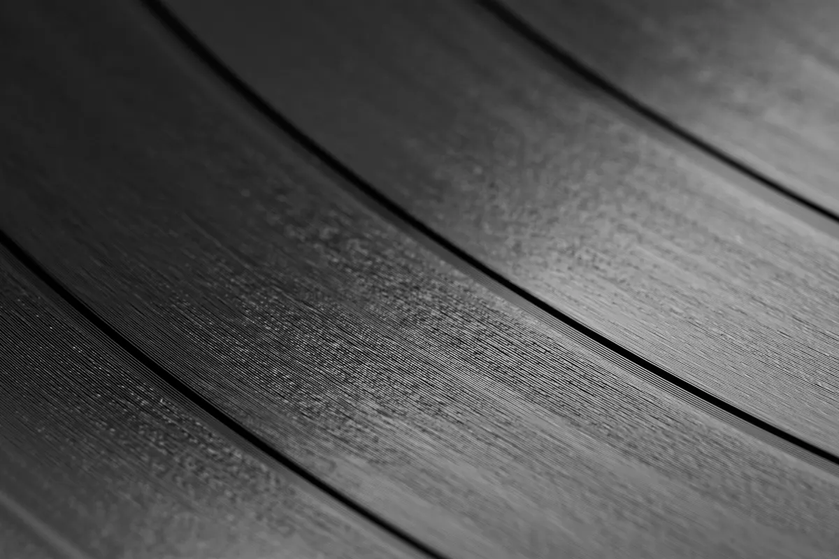 Close-up of the grooves and track gaps on a black vinyl record